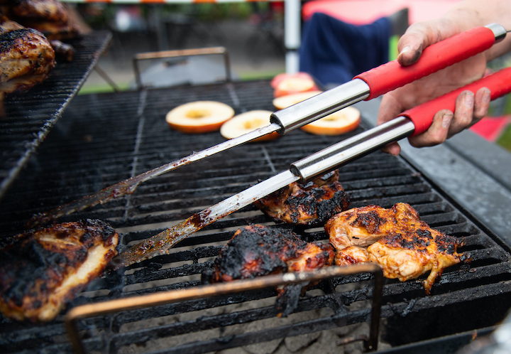 Chicken sizzles on the grill at the 2021 Cocky Cookoff